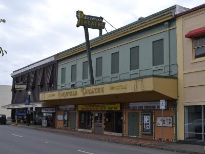 The image shows a street-level view of a building with a marquee that reads "Egyptian Theatre," situated on a street corner with other adjacent storefronts.
