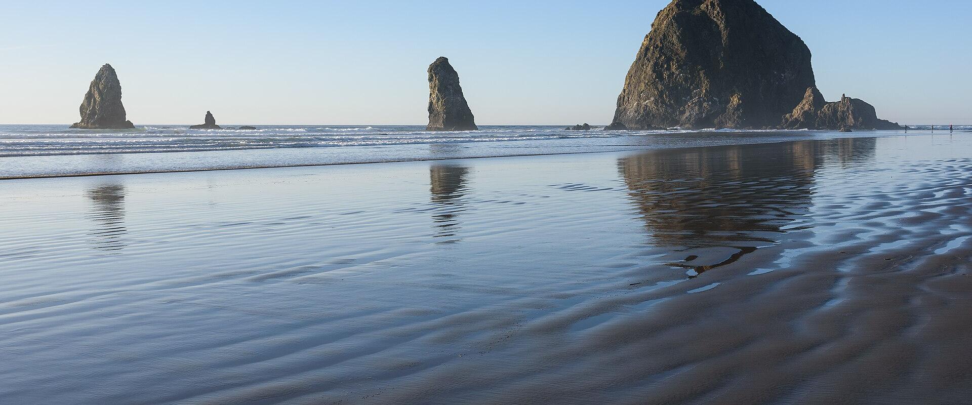 Haystack Rock rising from the beach at Cannon Beach, Oregon